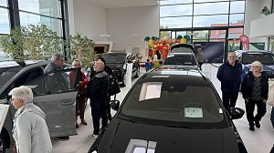 Besucherinnen und Besucher betrachten ausgestellte �koda-Fahrzeuge im Autohaus Autowelt Peter. Im Hintergrund ist eine bunte Hüpfburg für Kinder zu sehen.
